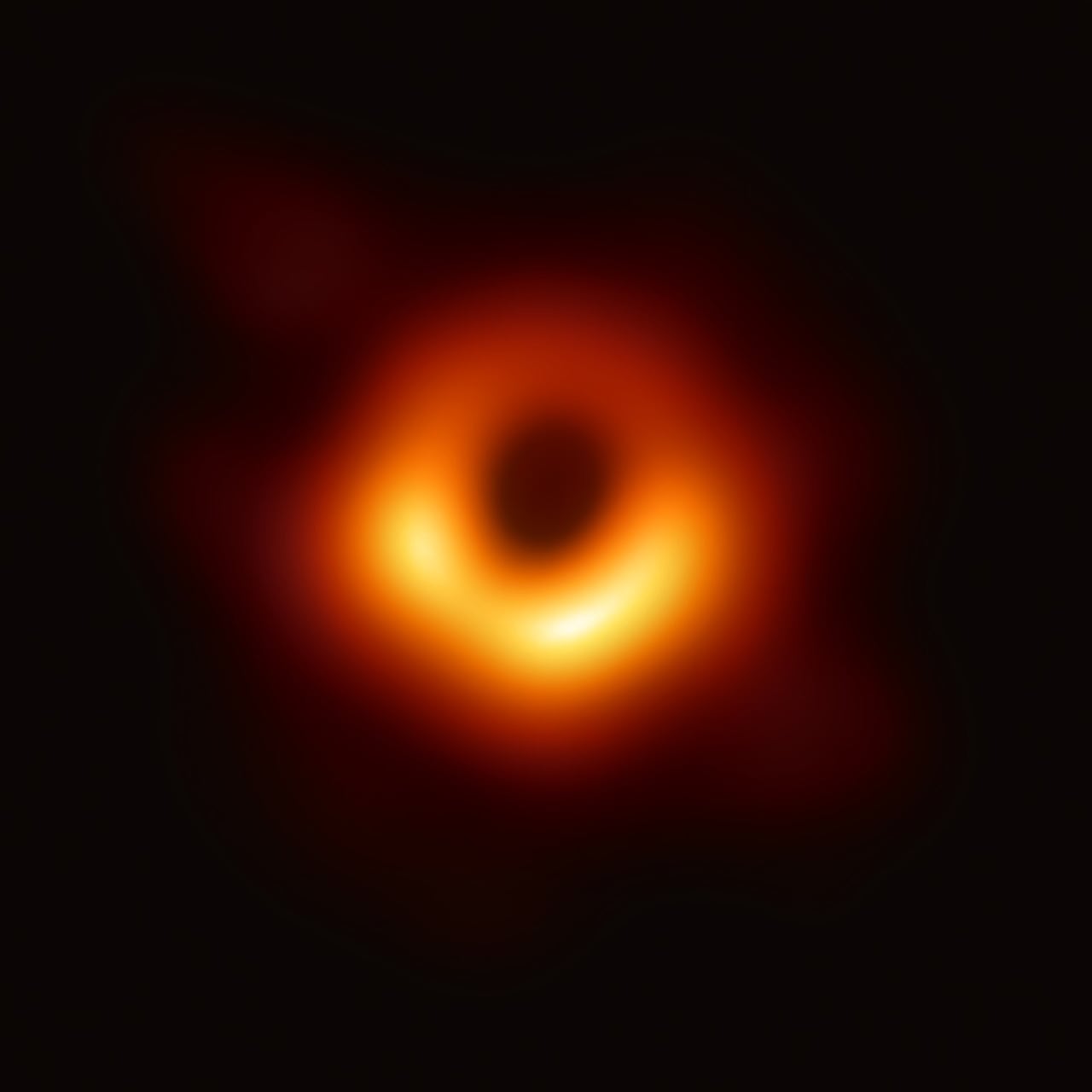 The Event Horizon Telescope's 2019 image of M87*: a bright orange ring of light around a dark central shadow.